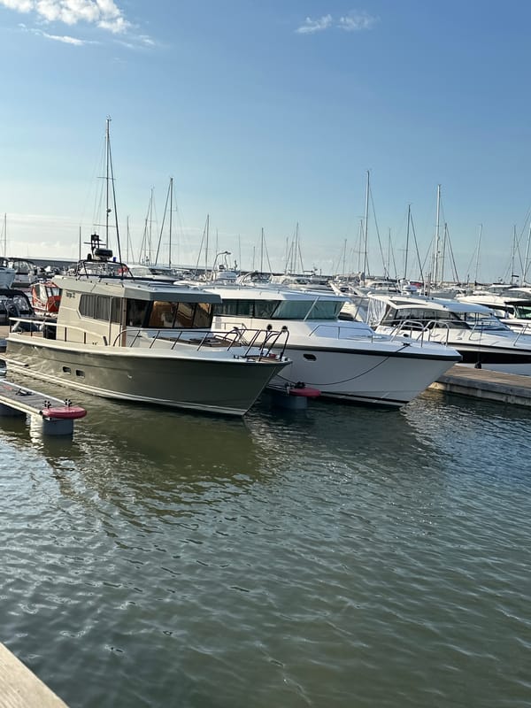 Tallinn marina on a sunny afternoon, boats docked and moving