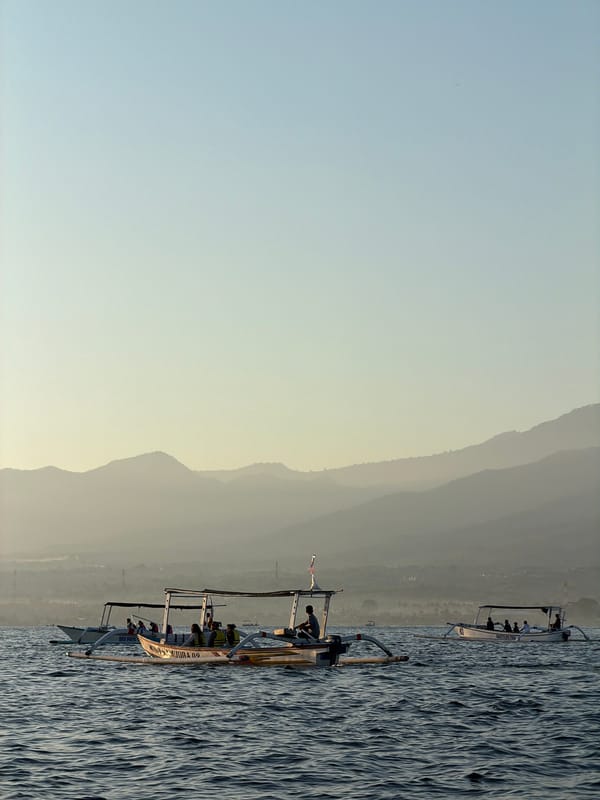 Outrigger boats crossing Buleleng waters at sunset