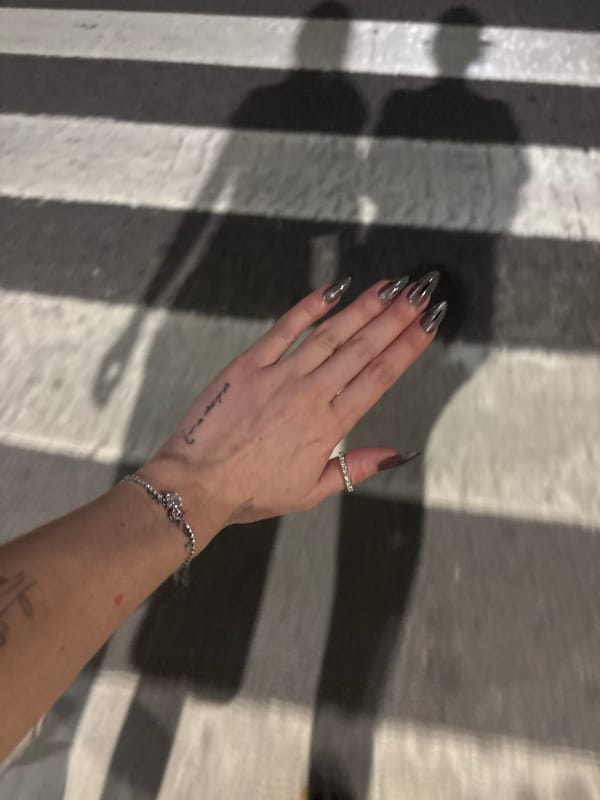 Manicured stiletto nails and jewelry displayed in Buenos Aires