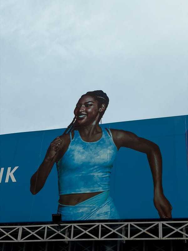 Athletic advertisement and modern building observed in Lagos area
