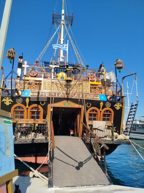 Ornate black and gold boat docked in a Sithonia harbor