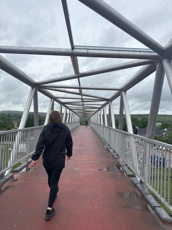Morning walk documented across pedestrian bridge in Strășeni, Moldova