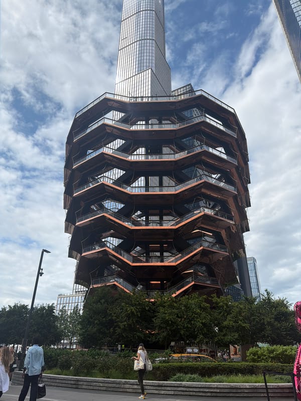 The Vessel at Hudson Yards, with a pink bear sculpture nearby