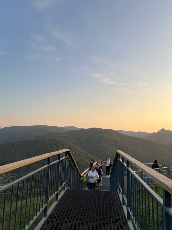 Dusk on a Krasnoyarsk hilltop, forested mountains stretching out below.