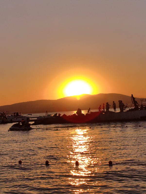 Gelendzhik beachfront at golden hour — sculptures, sea, and sunset