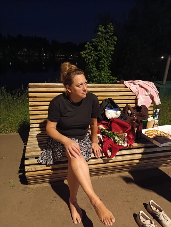 Nighttime gathering at a lit waterfront park path