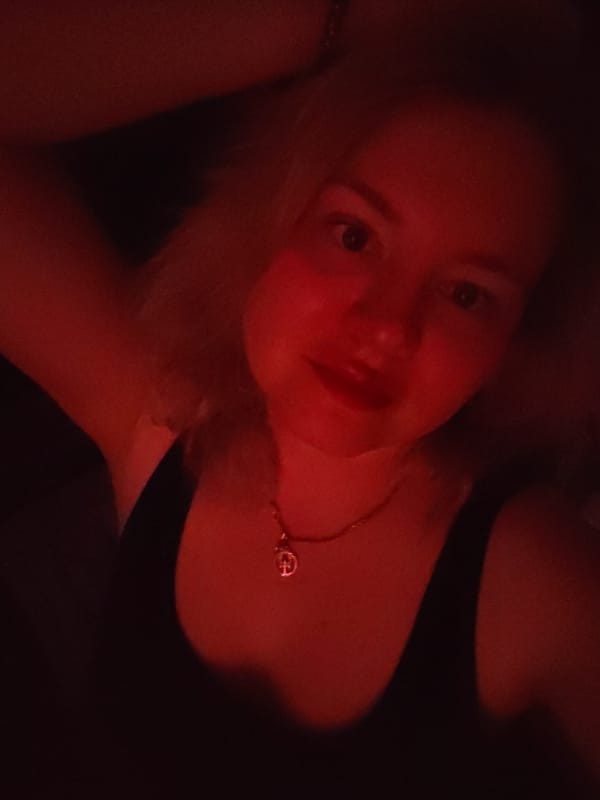 Woman takes selfies in red-lit room in Izhevsk