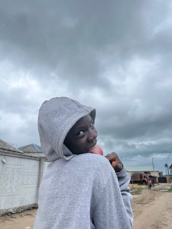 Young people gather on dirt roads in Badagry, Nigeria