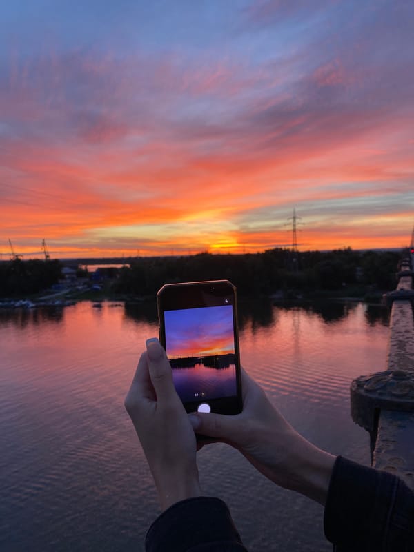 Sunset from a bridge, sky reflected on the river below