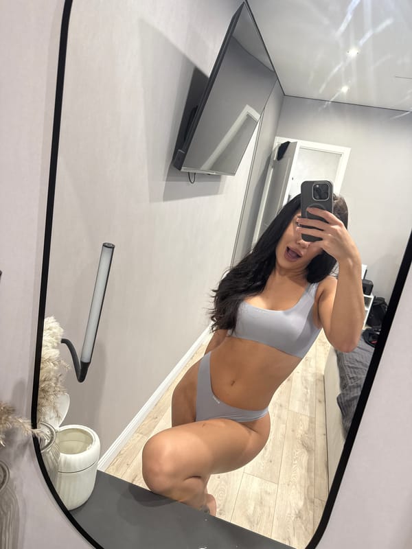Woman takes mirror selfies in bathroom in Kazan