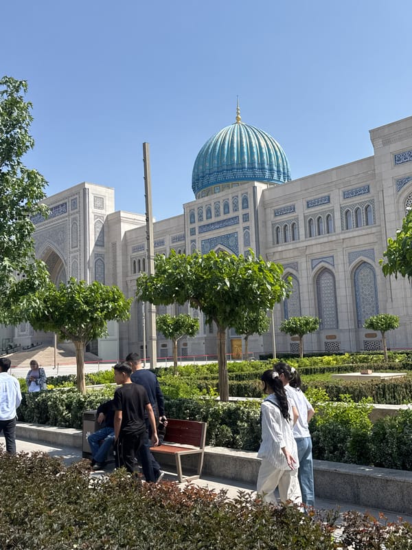 Woman sunbathes near historic Tashkent mosque complex