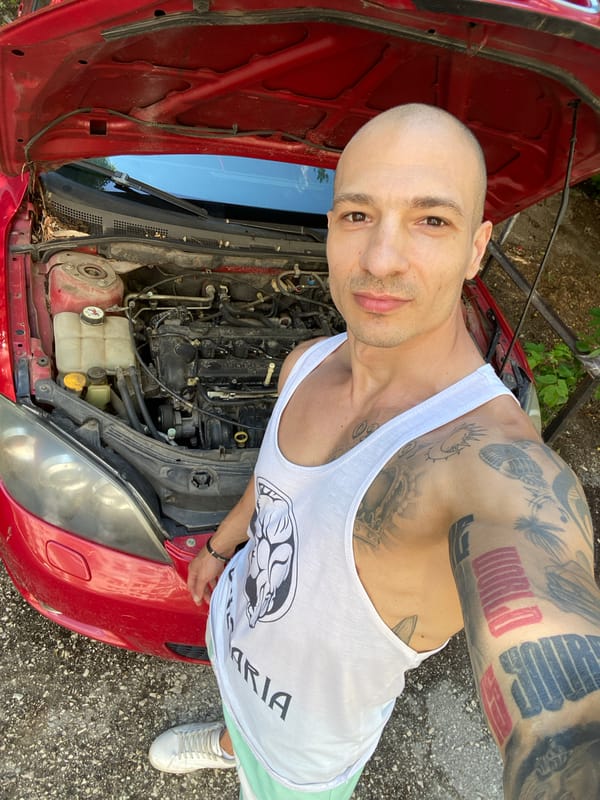 Man works on red car in Pleven, Bulgaria