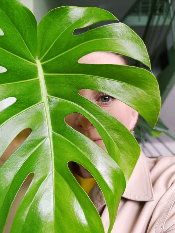 Woman documents morning selfie session with plant leaves in Russia