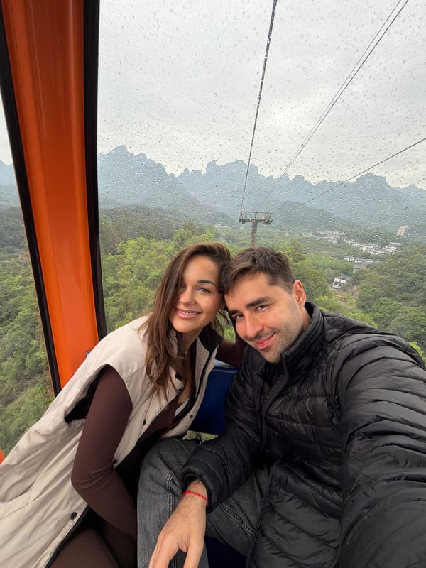 Couple rides Tianmen Mountain cable car during rainy morning