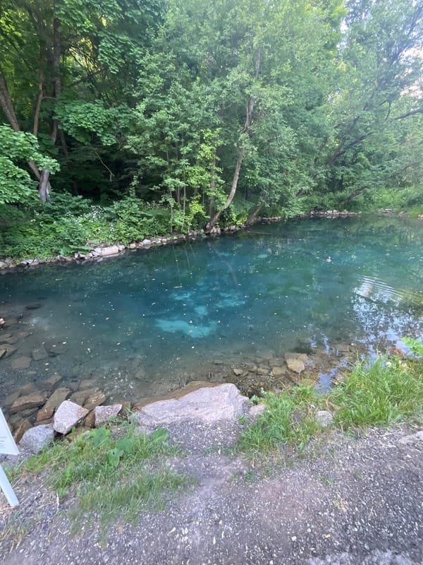 Crystal-clear turquoise water surrounded by green vegetation near Kazan