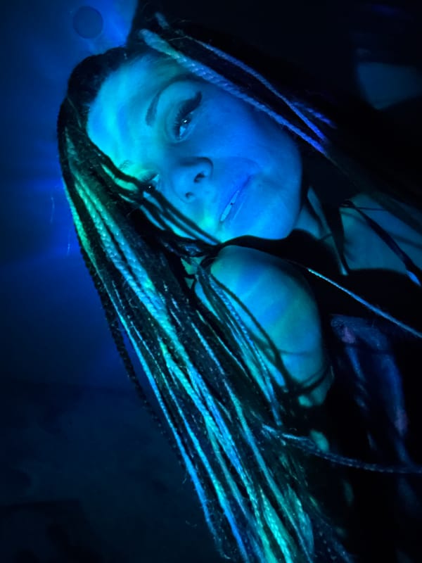 Artistic portrait session with colored lighting documented in Rusanovo