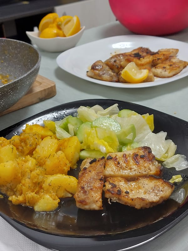 Home fish dinner prepared in Shumen kitchen with cat