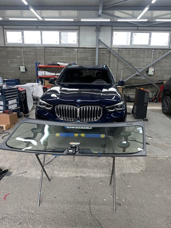 Windshield work in a garage, planes spotted overhead