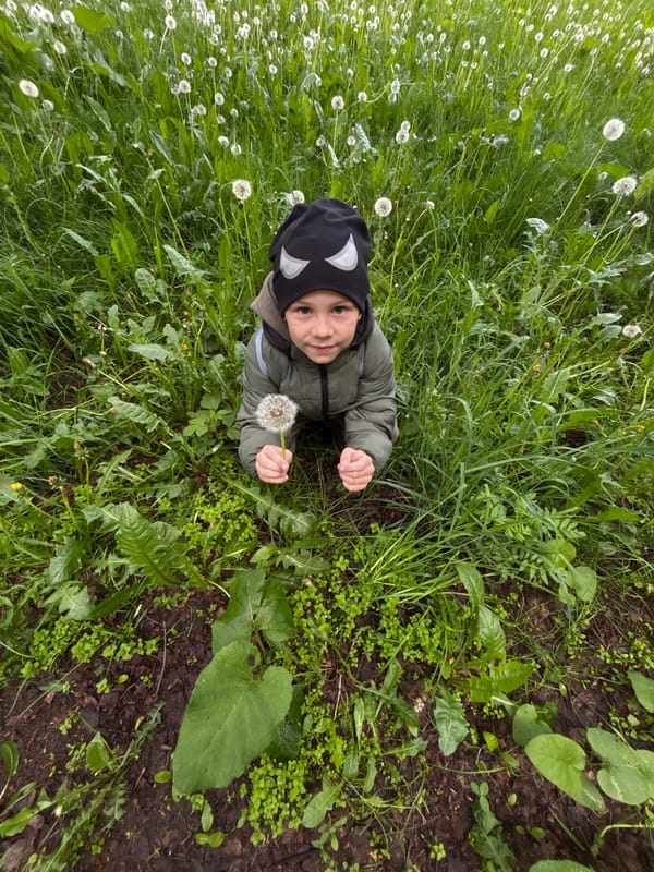 Mother and child enjoy dandelion moment in Yaroslavl park