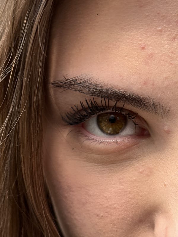 Two women pose for photos against concrete walls in Sofia