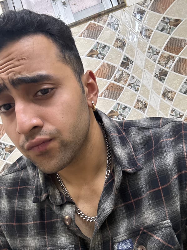 Man in plaid shirt photographed indoors in Kolkata