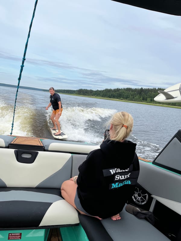 Wake surfing behind a boat on a Russian lake