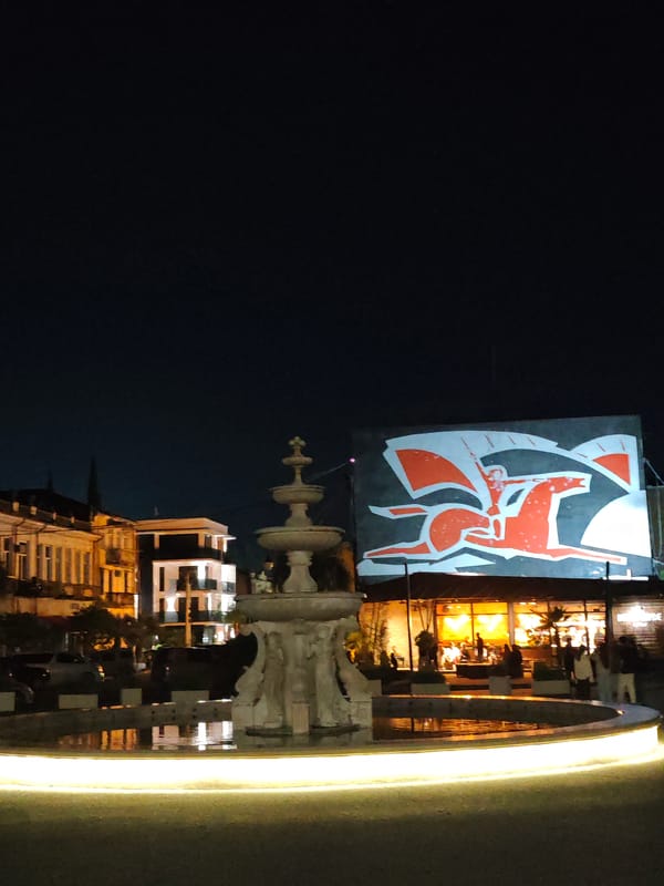 Bronze child statues documented in nighttime Sokhumi plaza