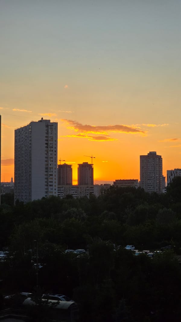 Kyiv apartment skyline glows during a summer evening sunset