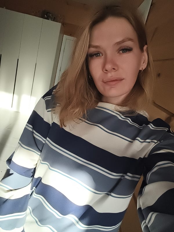 Young woman photographed indoors in Русский Вожой, Russia