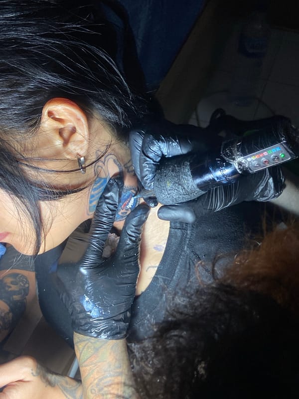 Tattoo session documented at Kuta studio, neck work completed