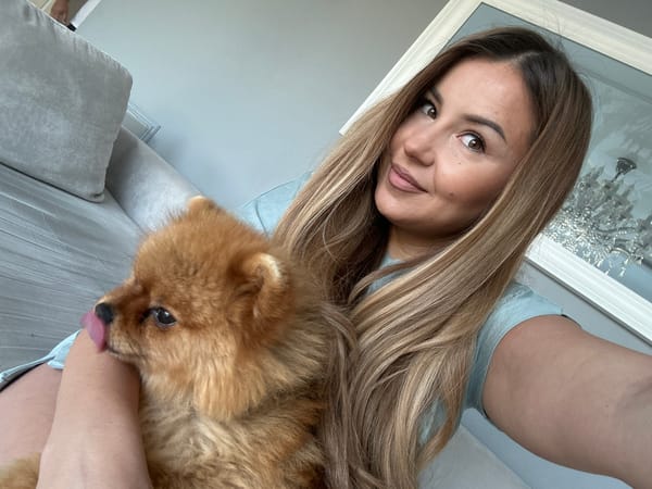 Woman photographs herself with Pomeranian dog in Bulgaria morning session