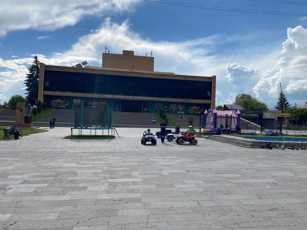 Witness documents Gyumri city center scenes, modern building and tiled sidewalk
