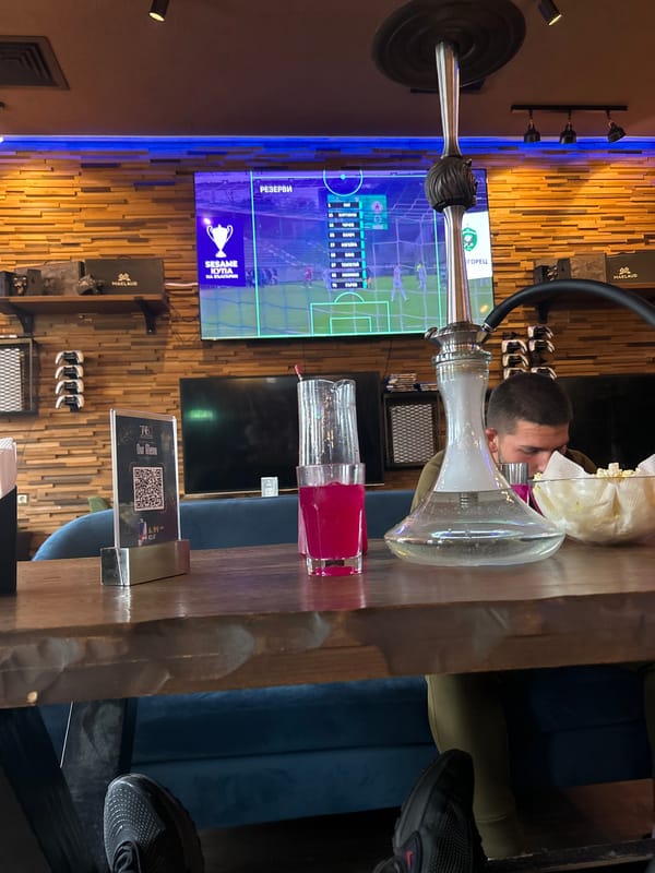 Man watches TV in Sofia cafe lounge