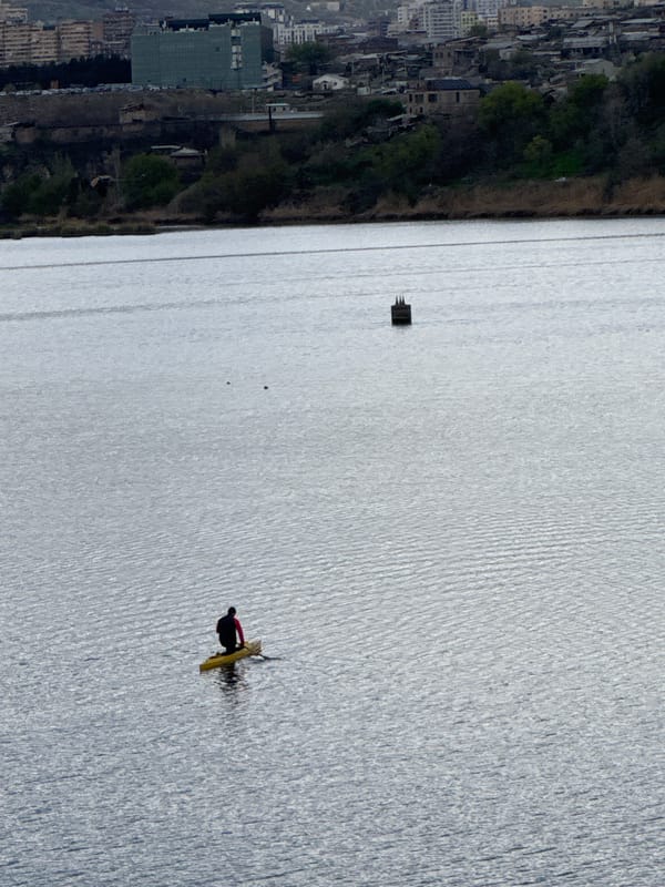 Kayaker spotted on Yerevan water body amid city skyline