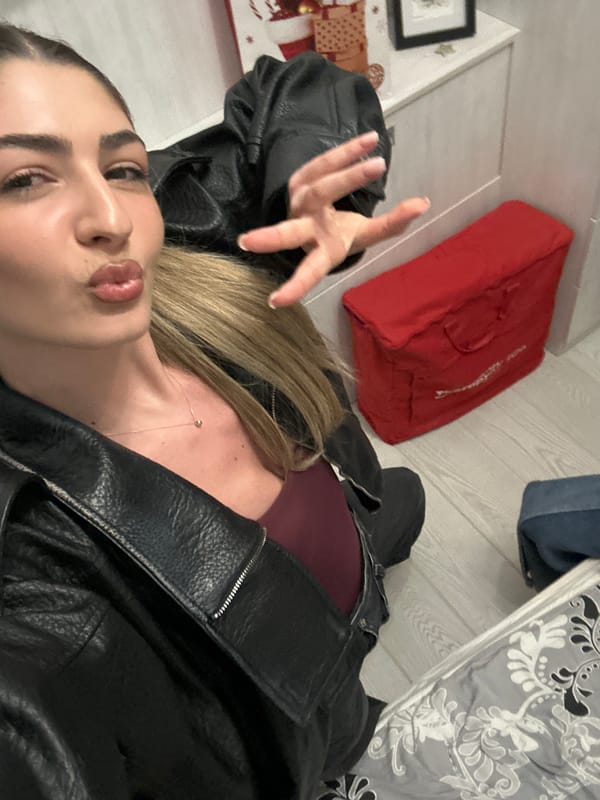 Women in leather jackets pose for selfies indoors
