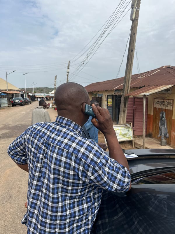 Campaign workers post election materials for candidate in Jos