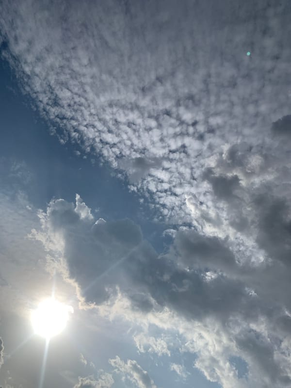Sunlit sky and a close-up portrait moment in Jos, Nigeria