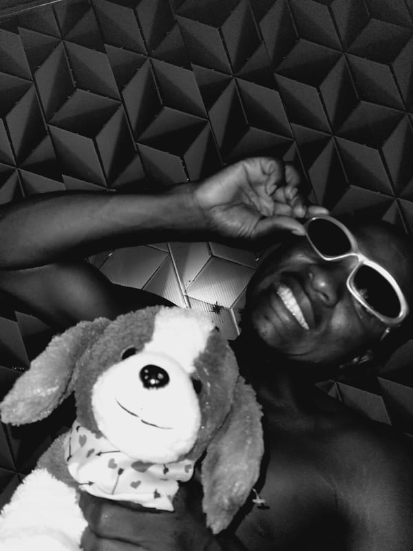 Man poses with stuffed dog during casual photo session