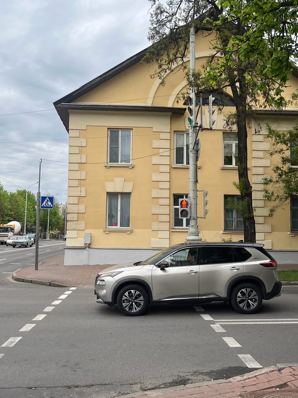 Silver SUV parked on Minsk street blocks sidewalk