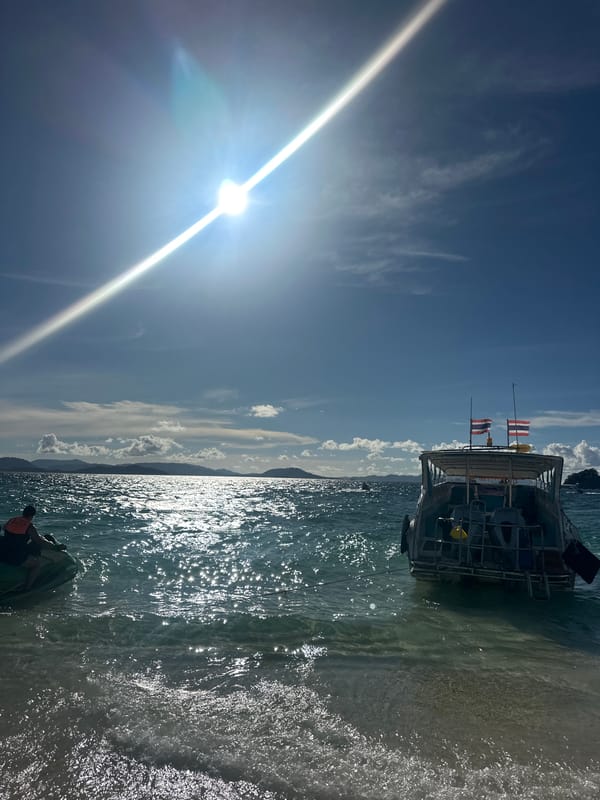 Bright morning at Phru Nai beach, people in the water