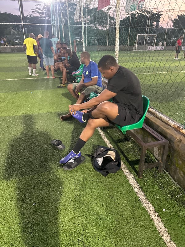 Evening football at a floodlit turf facility in Abuja