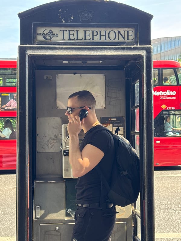 Man uses traditional phone booth near St. Paul's Cathedral