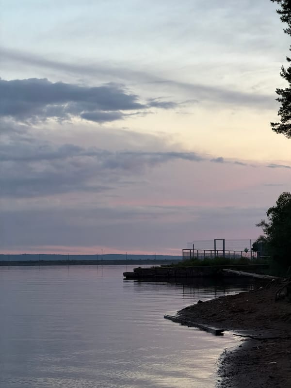 Cruise ships dock on Kama River as locals fish, photograph