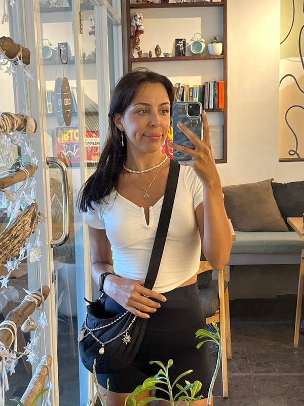 Woman takes selfies during morning shop visit in Kuta Selatan