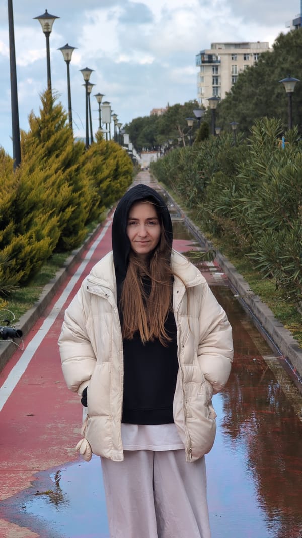 Woman walks dog, enjoys quiet morning on Kobuleti beach