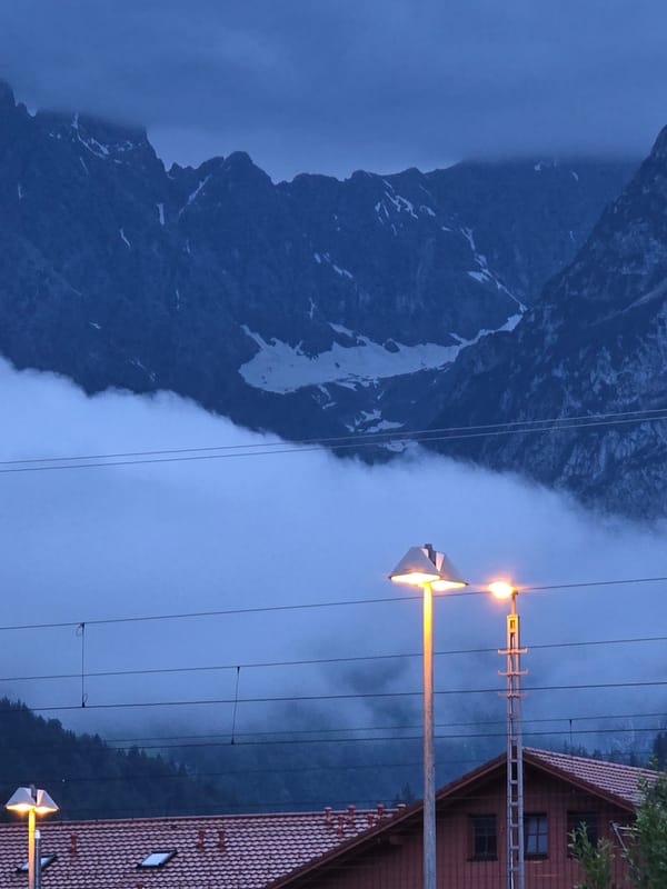 Evening drive through rainy Garmisch-Partenkirchen with mountain views