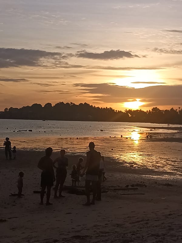 Families enjoy sunset beach time on Koh Phangan