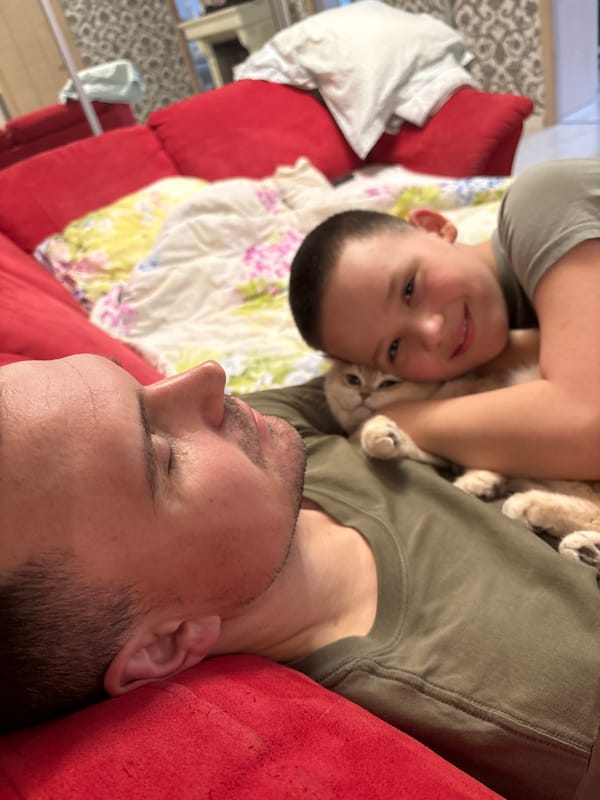 Family relaxes with cat during quiet morning in Chaikovsky