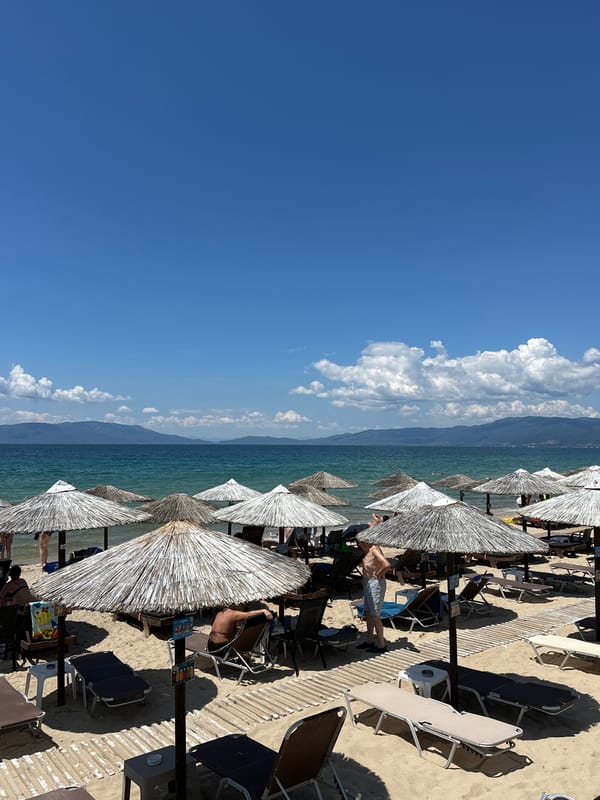 Crowded summer morning scene captured at Ofrynio Beach, Greece