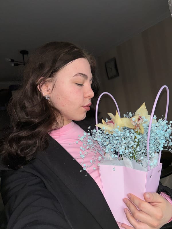 Woman holds flower gift bag in Perm